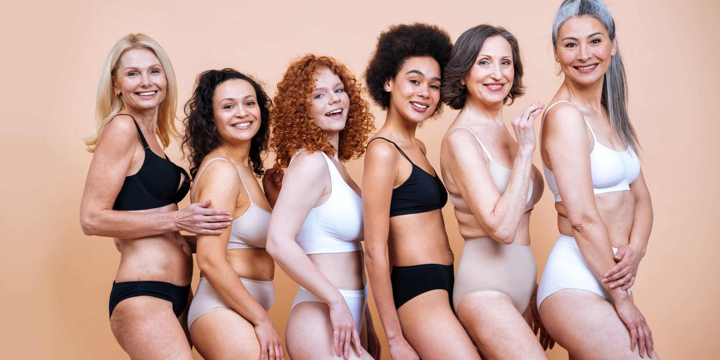 Smiling Females Wearing Lingerie Against Colored Background